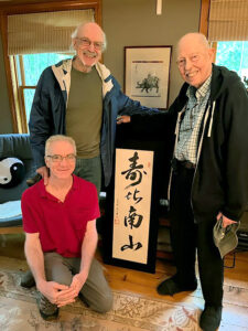 David Shaver presented with calligraphy by Lorelei Chang